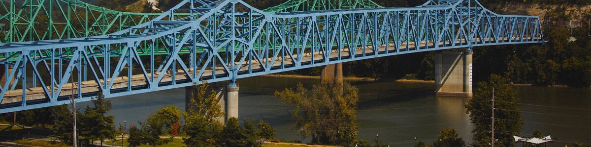 Scenic shot of the blue Owensboro Bridge against the green valley background in Indiana