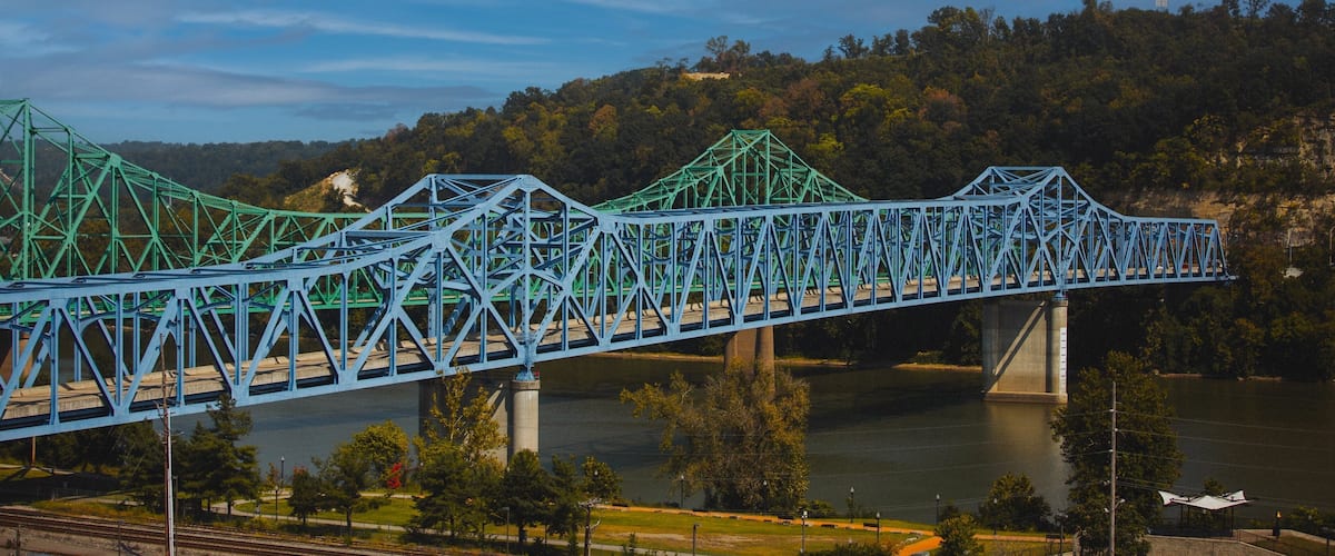 Scenic shot of the blue Owensboro Bridge against the green valley background in Indiana