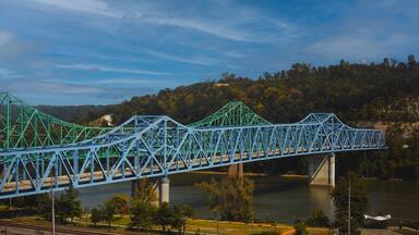 Scenic shot of the blue Owensboro Bridge against the green valley background in Indiana