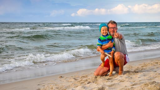 Dad and son on the beach - sunset on the Baltic Sea