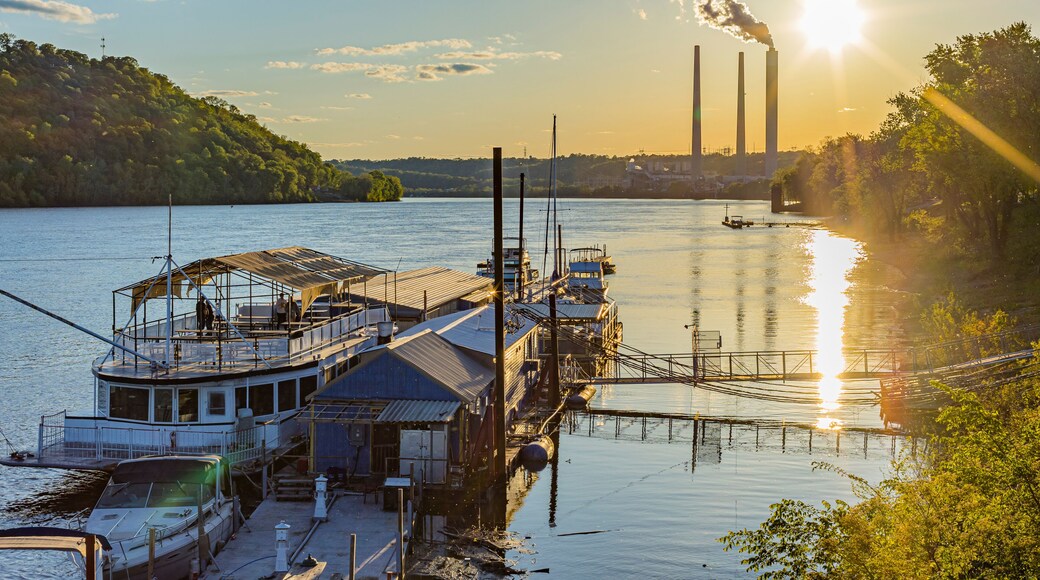 Shoreline of the Ohio River and the marina at Madison, Indiana at sunset with the power plant in the background.