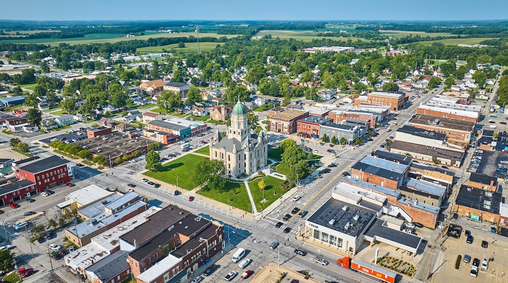Wide aerial view of Columbia City and Whitley County courthouse on bright sunny day