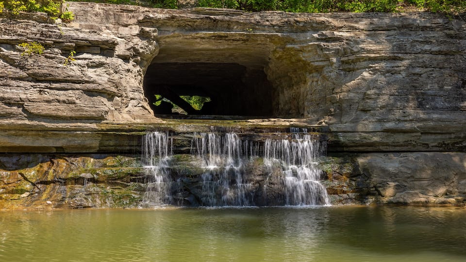 An old water diversion tunnel along a river.