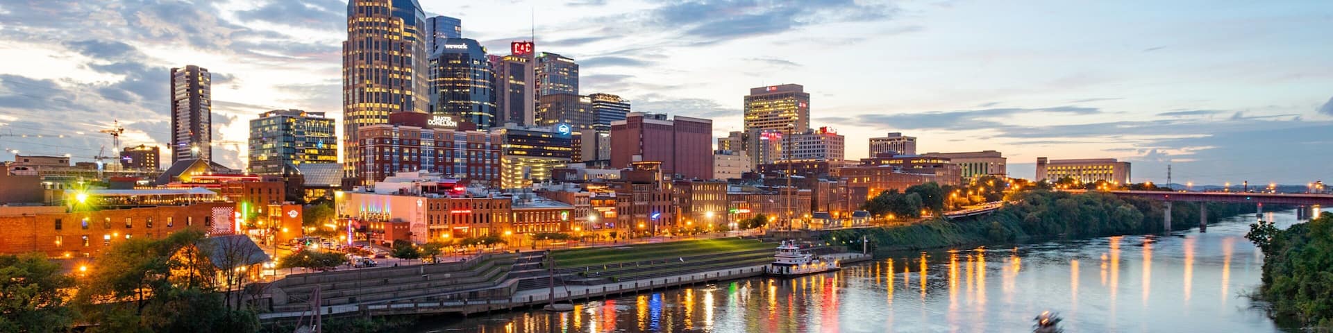 Downtown Nashville which includes a city, a sunset and boating
