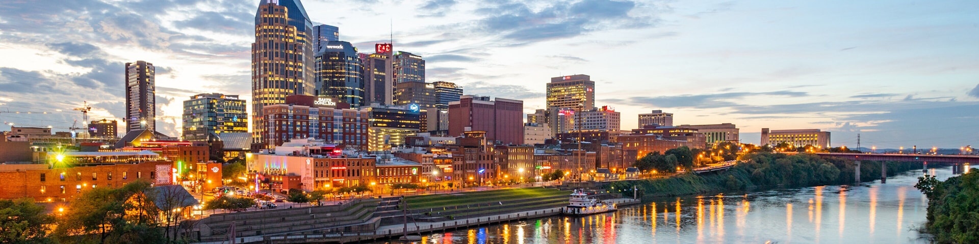 Downtown Nashville which includes a city, a sunset and boating
