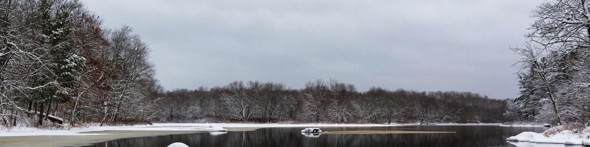 Boulders covered with snow in the West fork of the Chippewa river in northwest Wisconsin.