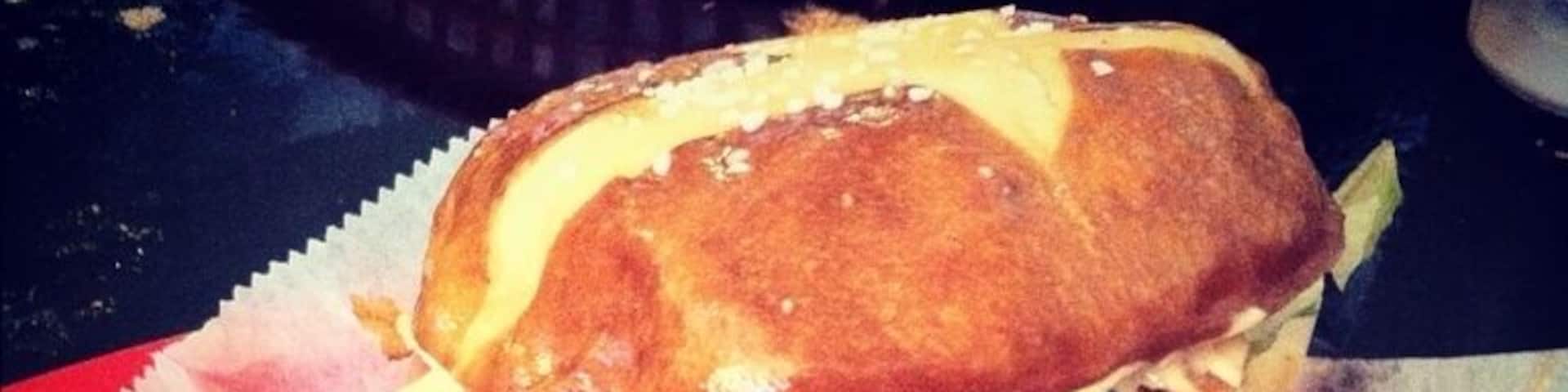 Literally the best burger I've had in my life. Burger topped with bacon, fried pickles, French fries, and cheese on a pretzel bun!