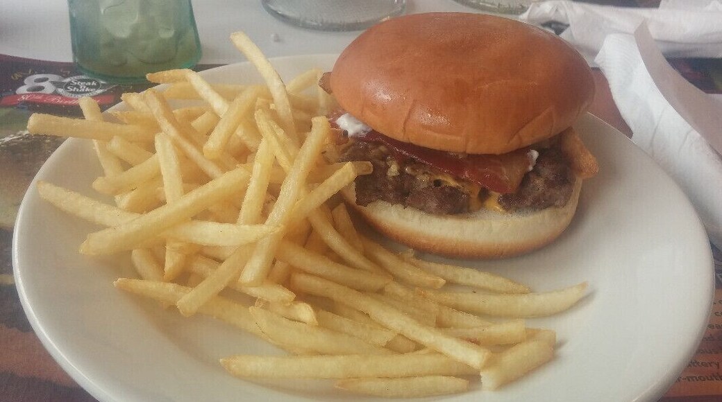 A Single Steakburger topped with melted American cheese, crispy bacon, French's French Fried Onions and zesty horseradish sauce.