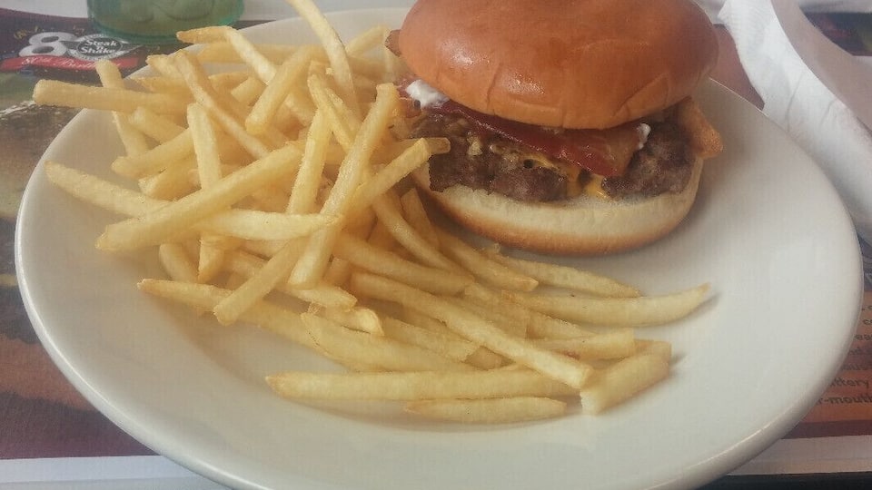 A Single Steakburger topped with melted American cheese, crispy bacon, French's French Fried Onions and zesty horseradish sauce.