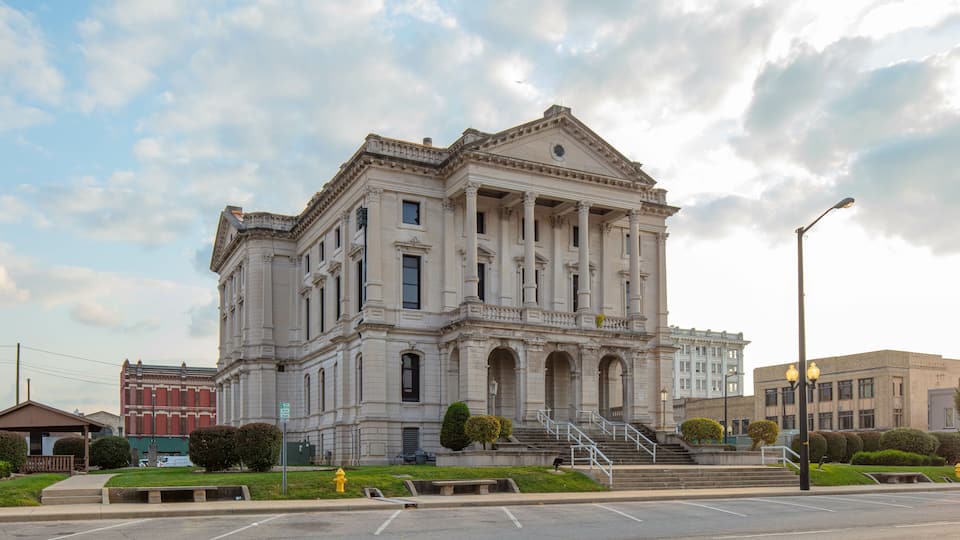 A large, historic building with classical architecture, including columns and a grand staircase.