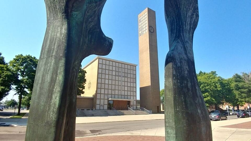 A large abstract sculpture in an urban setting.