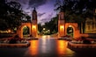 A well-lit entrance with arched gateways and a brick pathway.