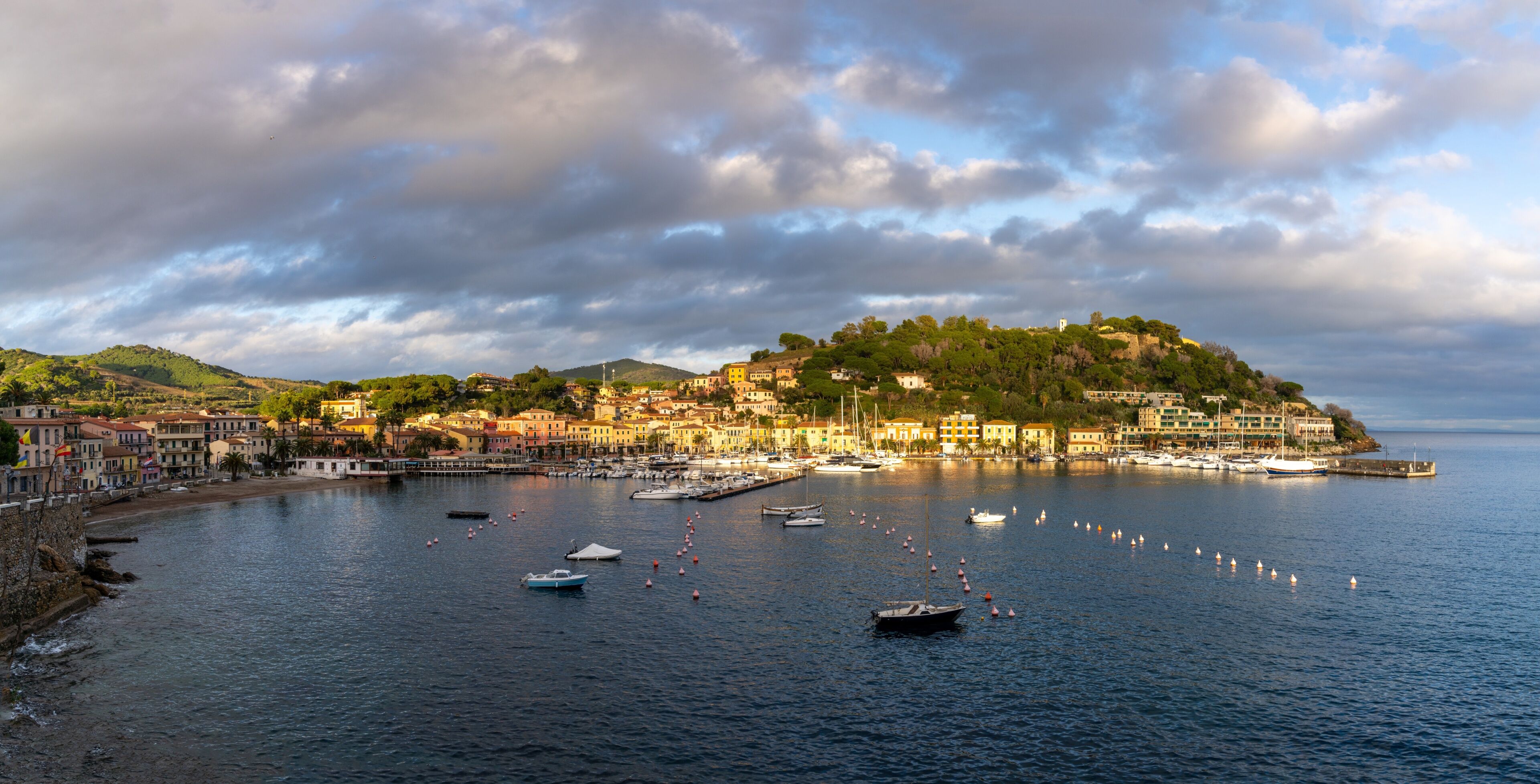 panorama view of the harbor marina and Porto Azzurro village on Elba Island at sunset
