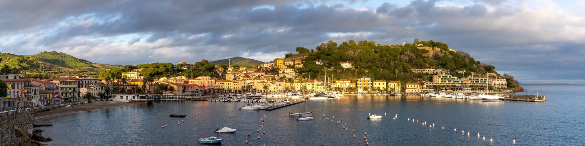 panorama view of the harbor marina and Porto Azzurro village on Elba Island at sunset