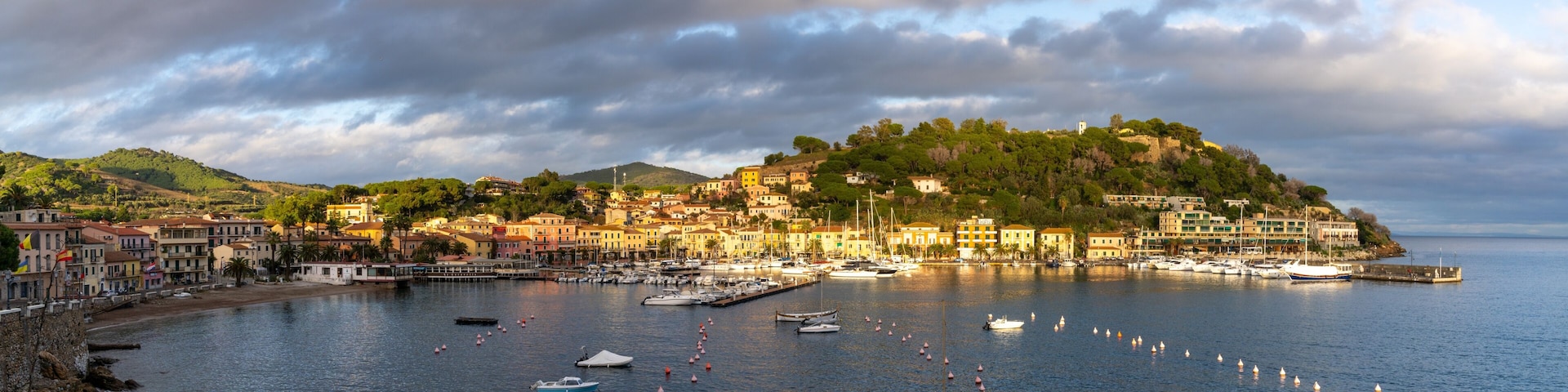panorama view of the harbor marina and Porto Azzurro village on Elba Island at sunset