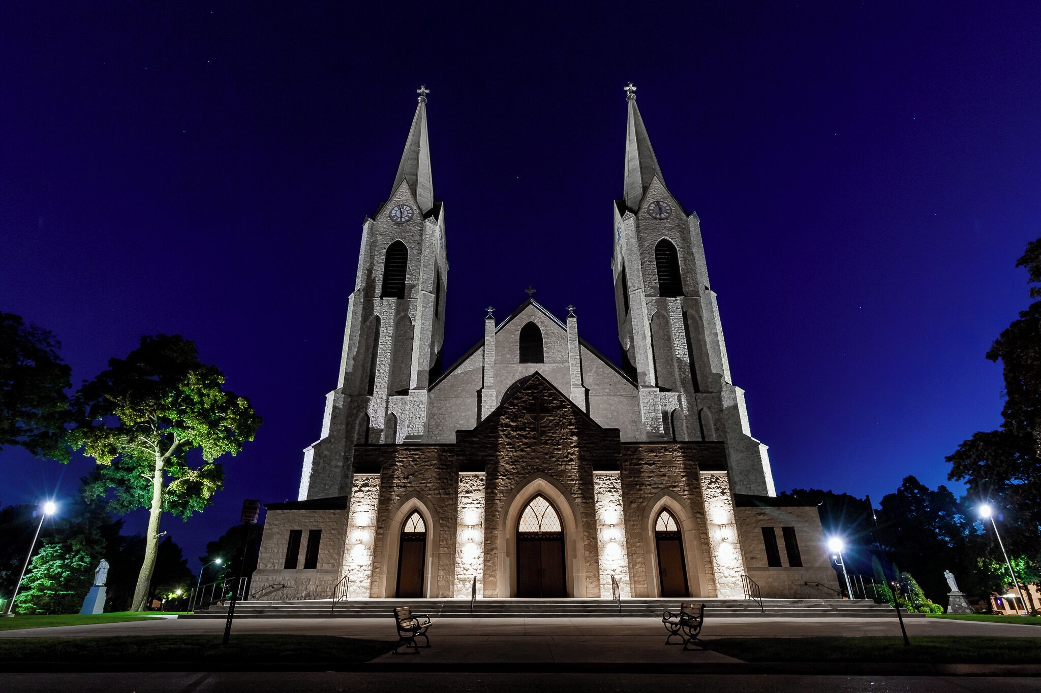 This church is lit up like day time all night long. Driving to Lake Michigan for photos over the last 5 years, this church stands out like a sore thumb.

A quick right and left from the main route to the lake and you are sitting right in front of it.

Taken early in the morning during a blue light sunrise. A wide angle lens makes the building look totally ominous, don't you think?