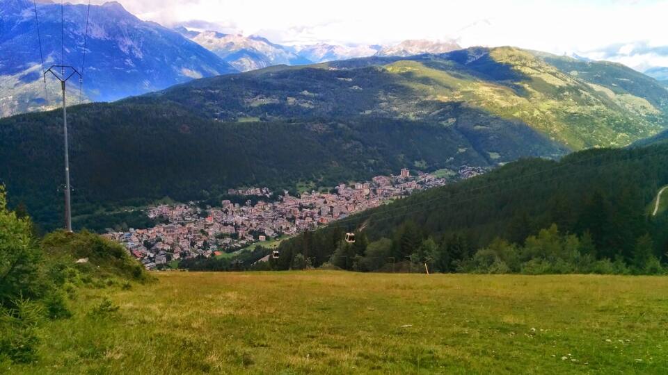 A mountainous landscape with a town nestled in the valley.