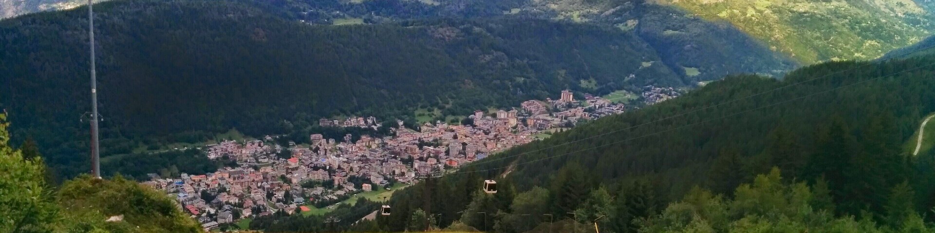 A mountainous landscape with a town nestled in the valley.