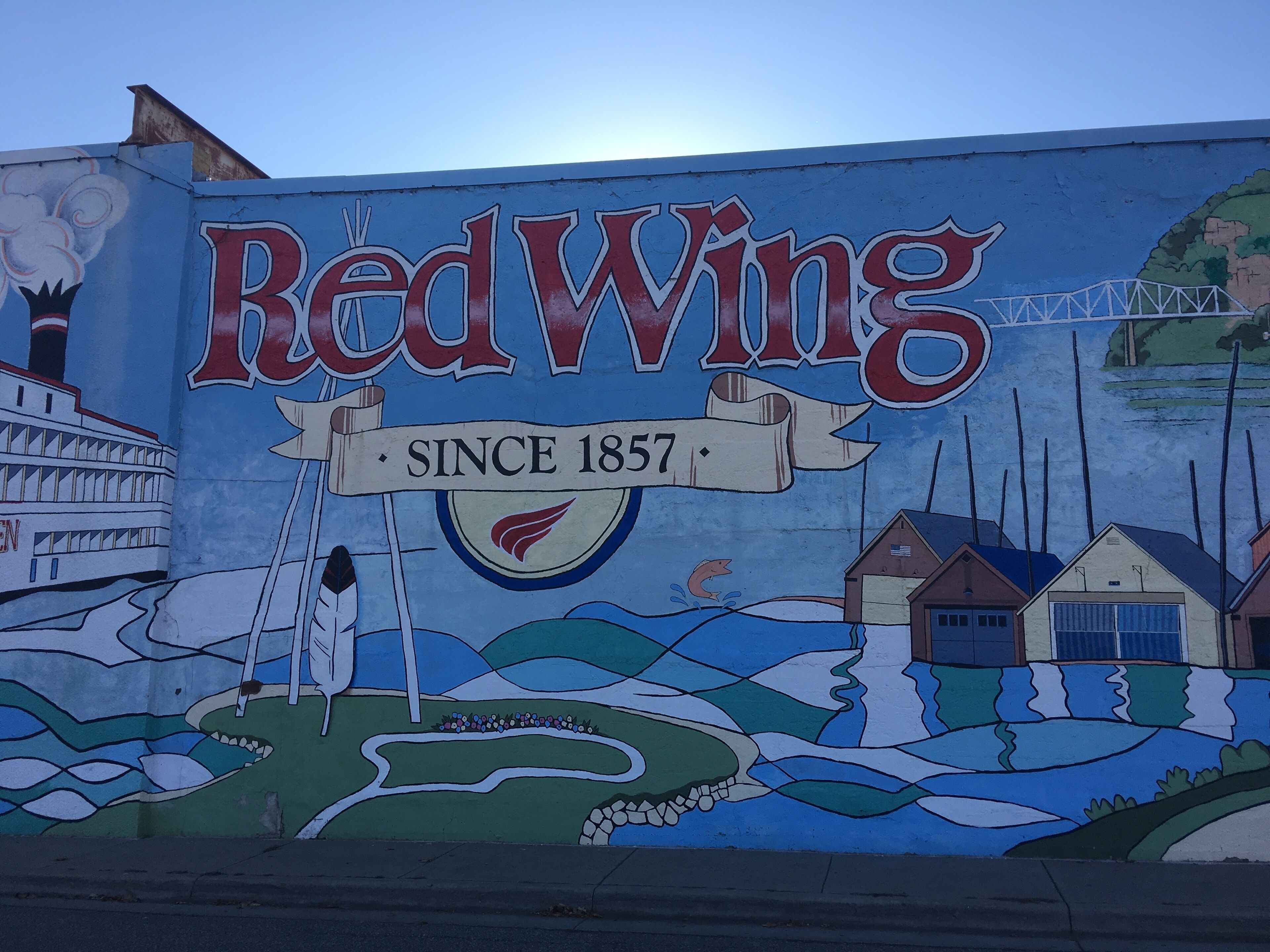 A mural of Red Wing with a steamship, houses, and a bridge.