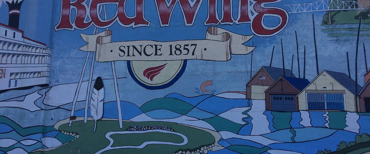 A mural of Red Wing with a steamship, houses, and a bridge.