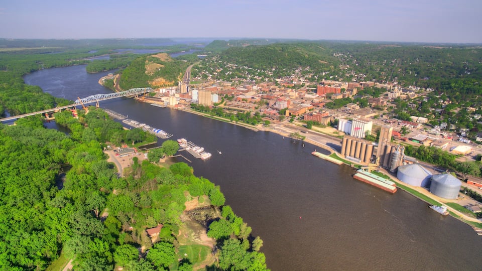 A river with a bridge, industrial buildings, and a town.