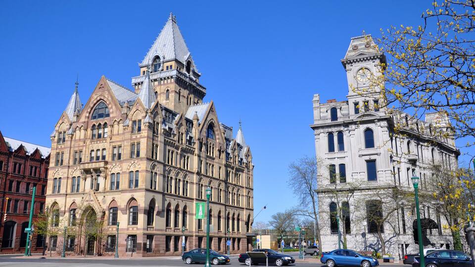 A historic building with pointed towers and a clock tower.