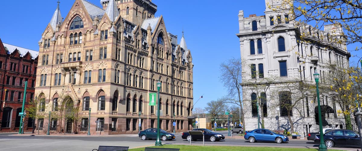 A historic building with pointed towers and a clock tower.