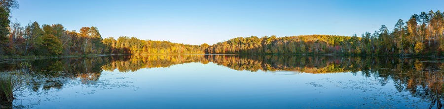 Panorama of a calm trout lake in northern Minnesota at sunset during autumn