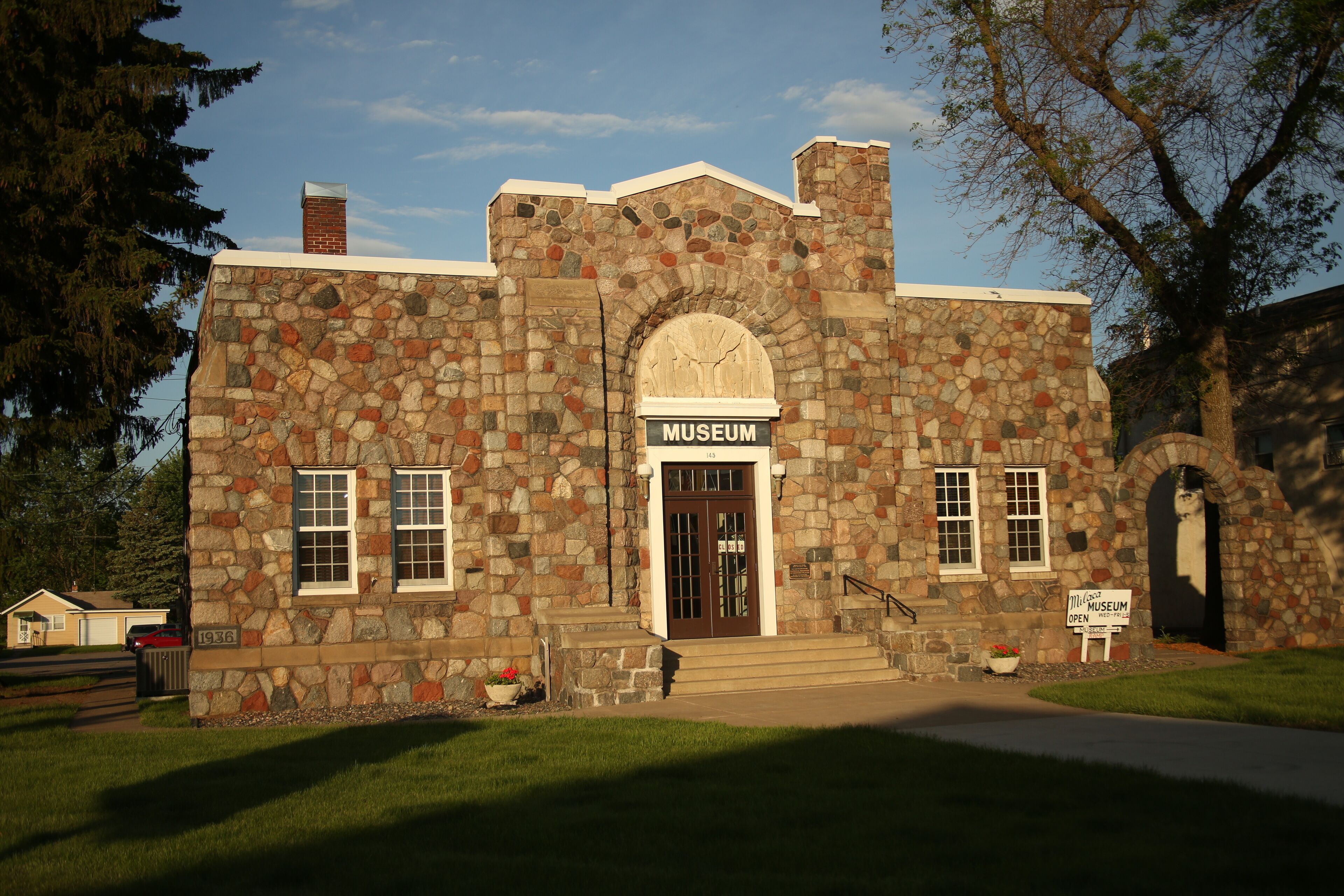 A stone building with a sign that reads "Museum."