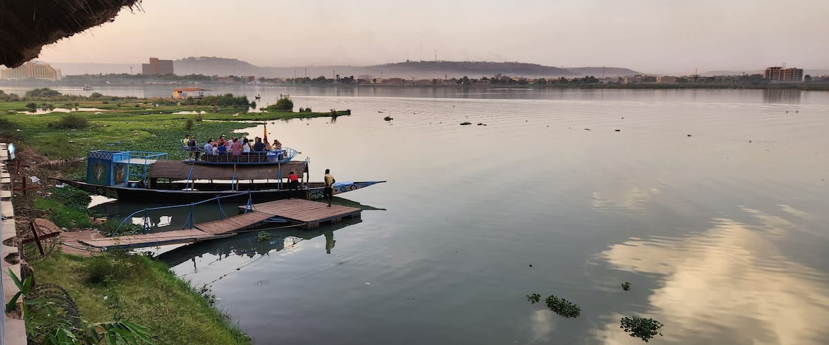 A calm river with a dock and a boat.