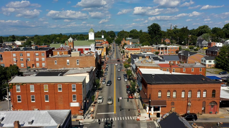 A town with a central street, historic buildings, and a church steeple.