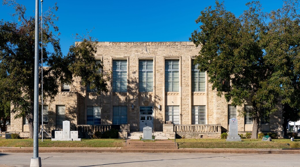 A historic building with large windows and a stone facade.