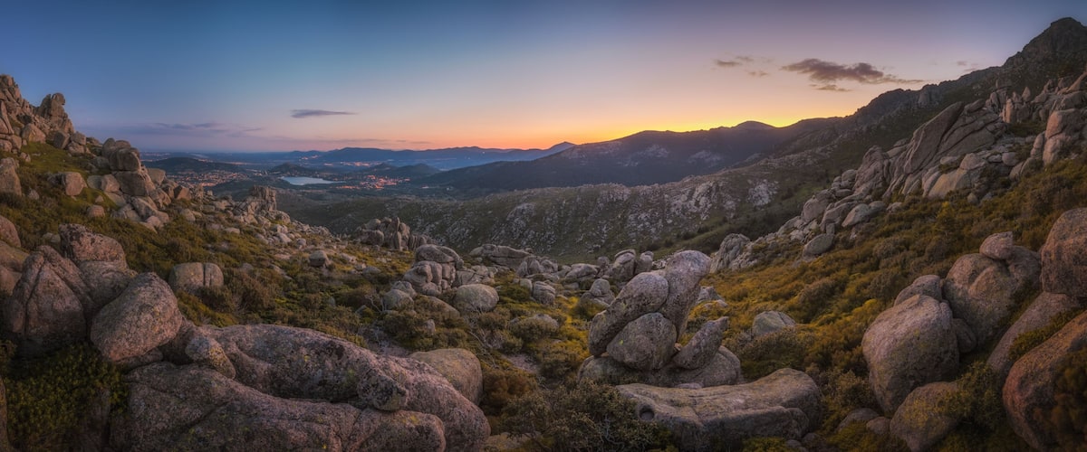A mountainous landscape with rocky terrain and sparse vegetation.