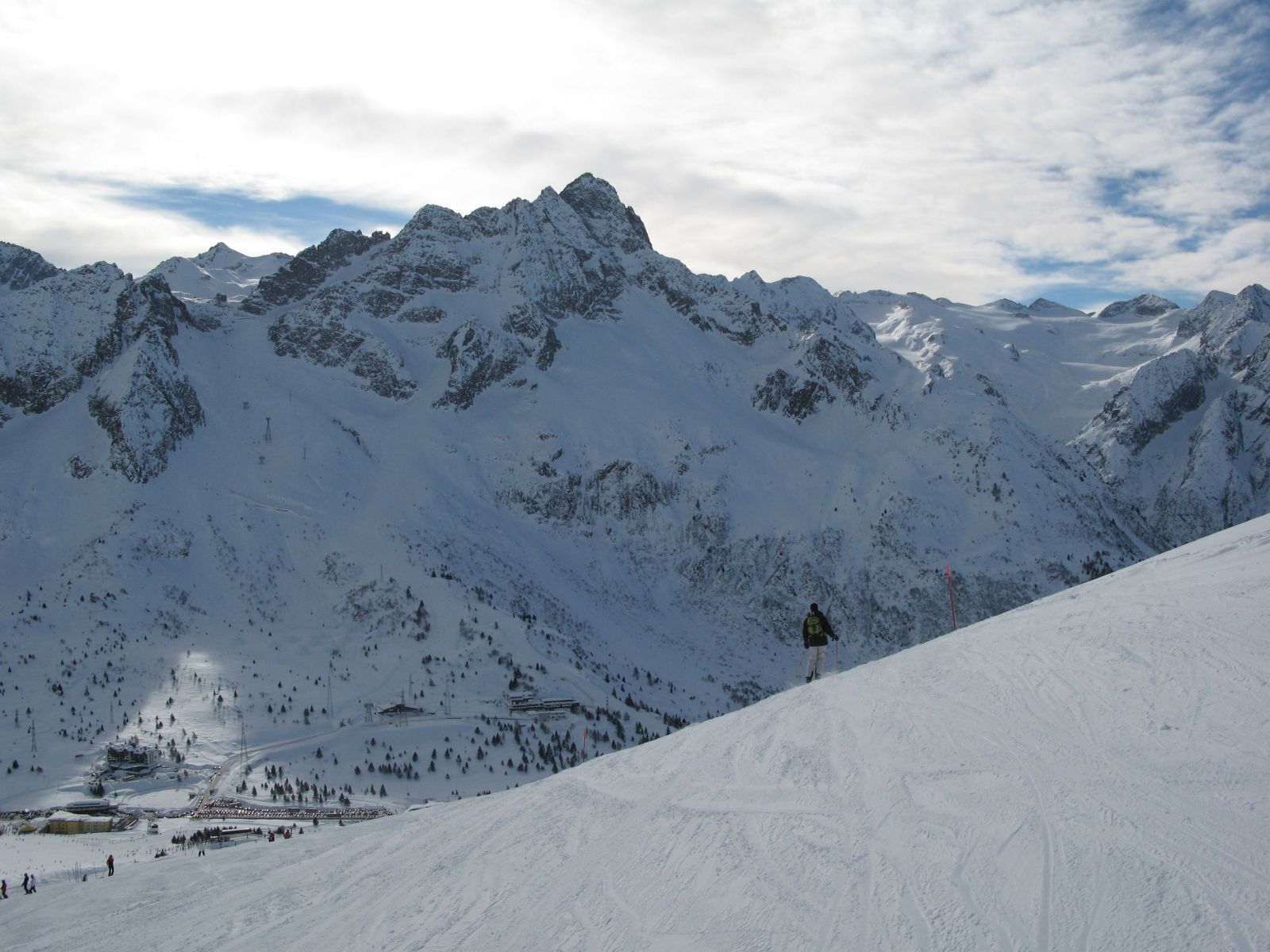 A snow-covered mountain range with a ski slope and a ski lift.