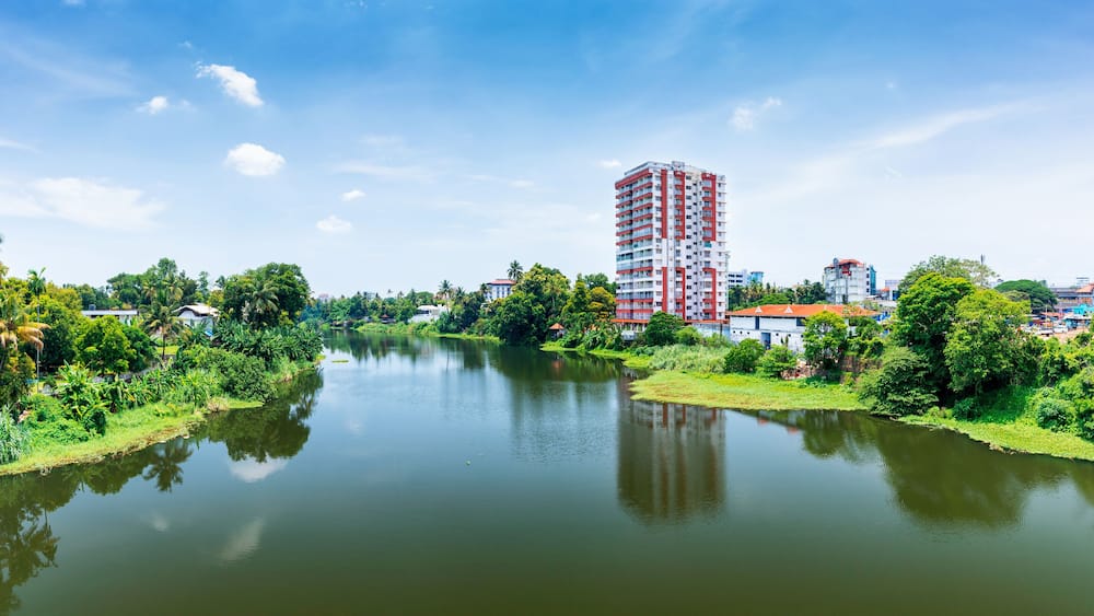 Ein Fluss mit einem hohen Gebäude im Hintergrund.