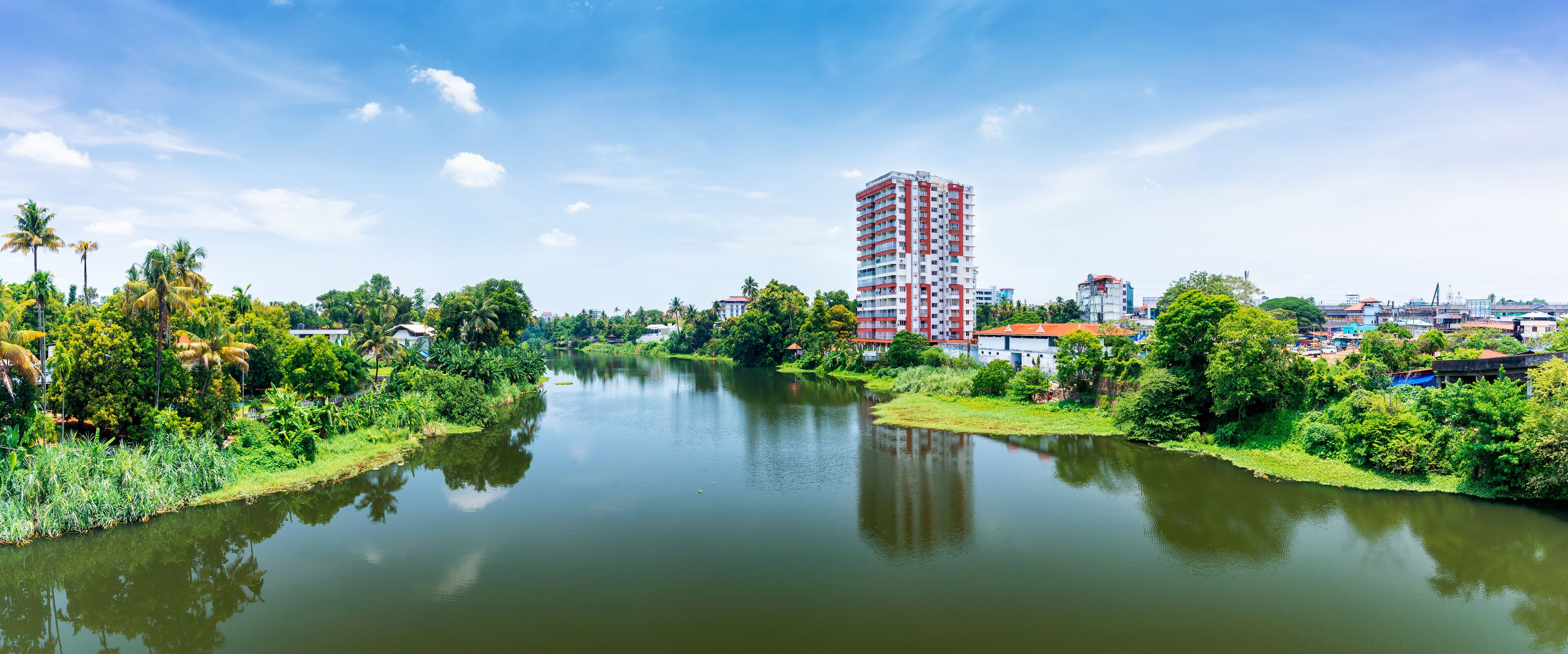 A river with a tall building in the background.