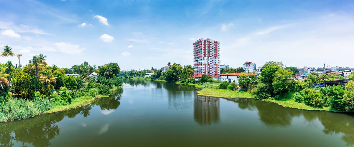 A river with a tall building in the background.