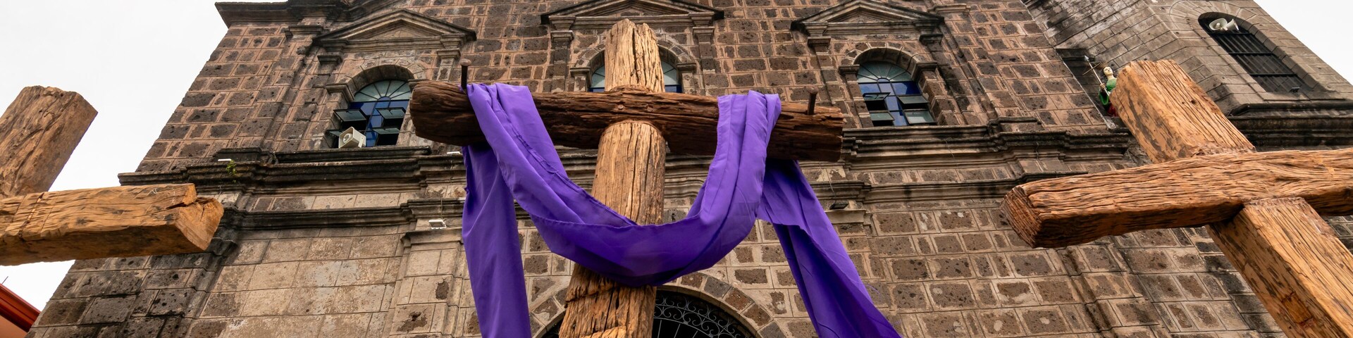 Binangonan, Rizal, Philippines - Crosses readied for Good Friday procession, in front of the facade of the Sta. Ursula Parish Church.