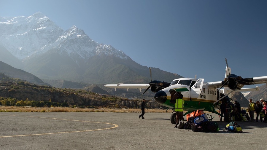 Trekking in Upper Mustang usually begins in this airport. 
This flight has just arrived from Pokhara.
The mountain on the background is Nilgiri
