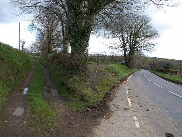 Track and road, Worden Cross. The A388 swings away to cross Fishpool Lake at Horrellsford, while the track on the left crosses it a little further north. Across the road on the right is 740930.