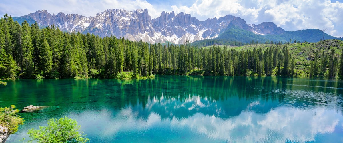 Paradise scenery at Karersee (Lago di Carezza, Carezza lake) in Dolomites of Italy at Mount Latemar, Bolzano province, South tyrol. Blue and crystal water. Travel destination of Europe.