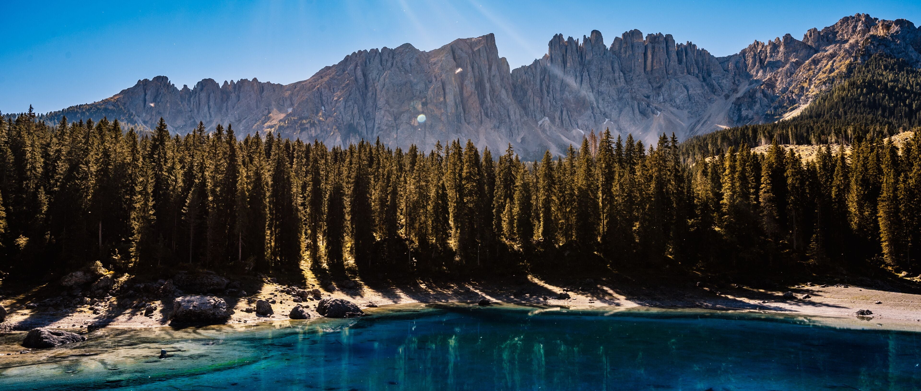 Landscape of Lake Carezza, Karersee with Dolomites, Nova Levante, Bolzano, Italy. Majestic landscape of Alpine red autumn Lake Carezza. Wonderful hiking nature scenery in dolomites