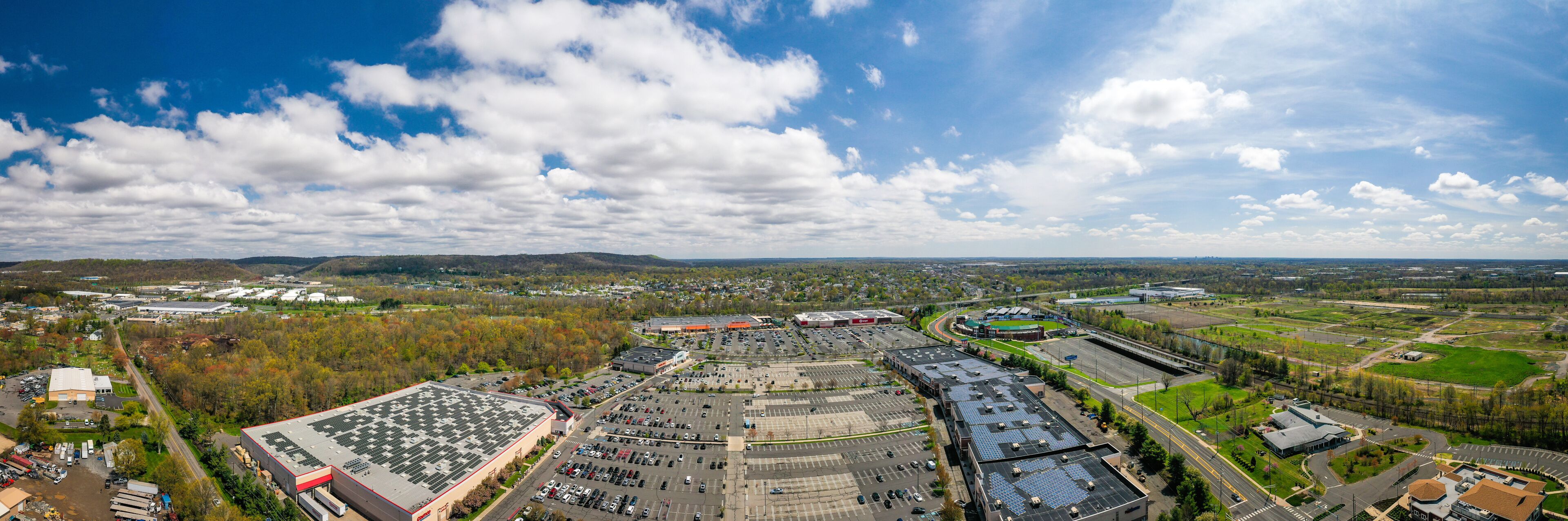 A large industrial area with multiple warehouses, parking lots, and a sports complex.