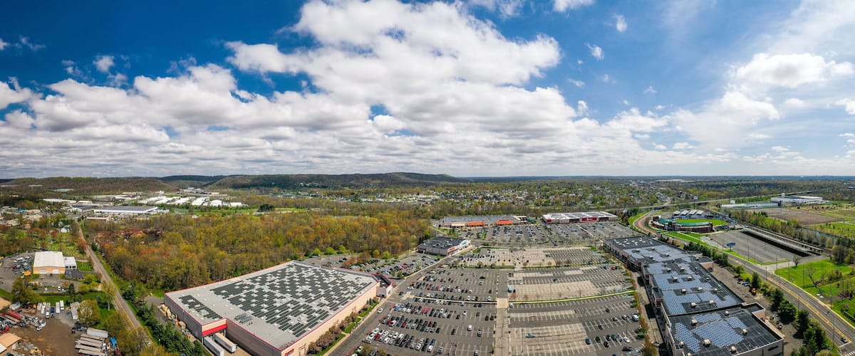 A large industrial area with multiple warehouses, parking lots, and a sports complex.