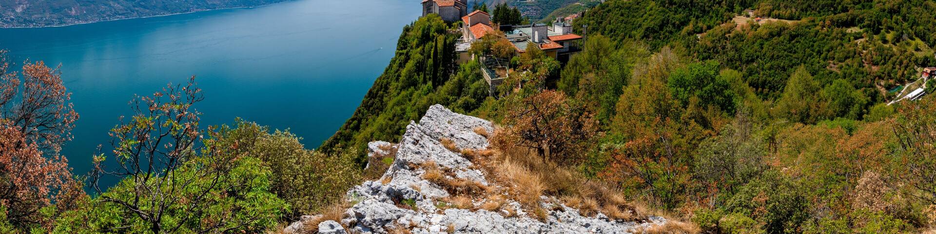 Lake Garda (Lago di Garda) with Pilgrimage church Madonna di Montecastello high above in the mountains near Tignale in Italy