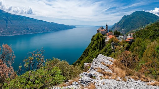 Lake Garda (Lago di Garda) with Pilgrimage church Madonna di Montecastello high above in the mountains near Tignale in Italy