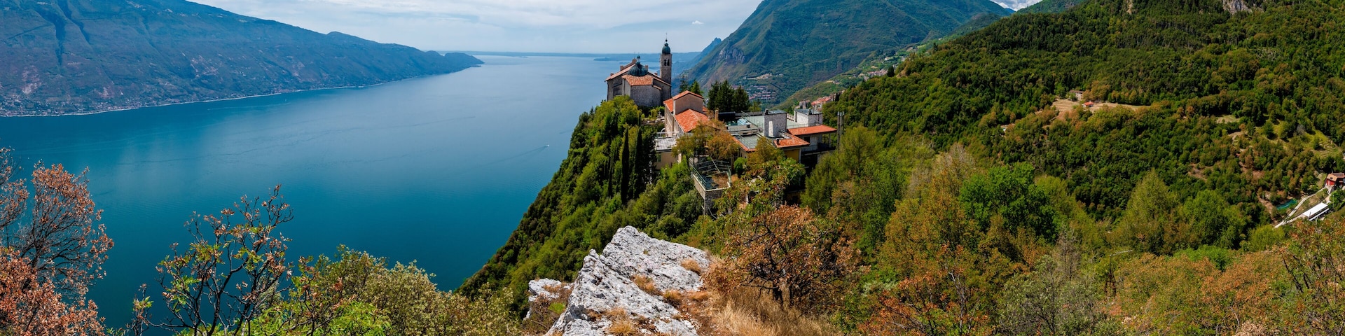 Lake Garda (Lago di Garda) with Pilgrimage church Madonna di Montecastello high above in the mountains near Tignale in Italy