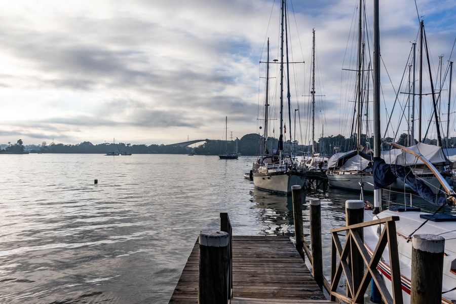 Boats and deck at the marina, Izabal Lake coast at the Caribbean sea, sky with white clouds, Sweet River, Puerto Barrios, Guatemala. tropical landscape background.