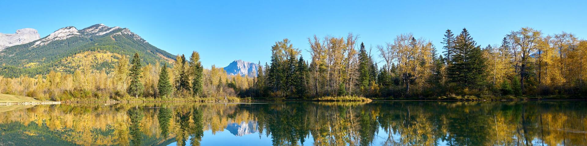 Maiden Lake Reflection Fernie British Columbia. A still, sunny day at Maiden Lake in Fernie BC in the Rocky Mountains.