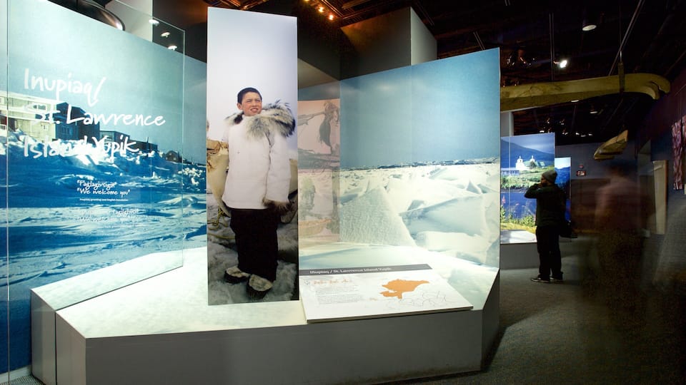 A display with a person standing in front of a backdrop of St. Lawrence Island.